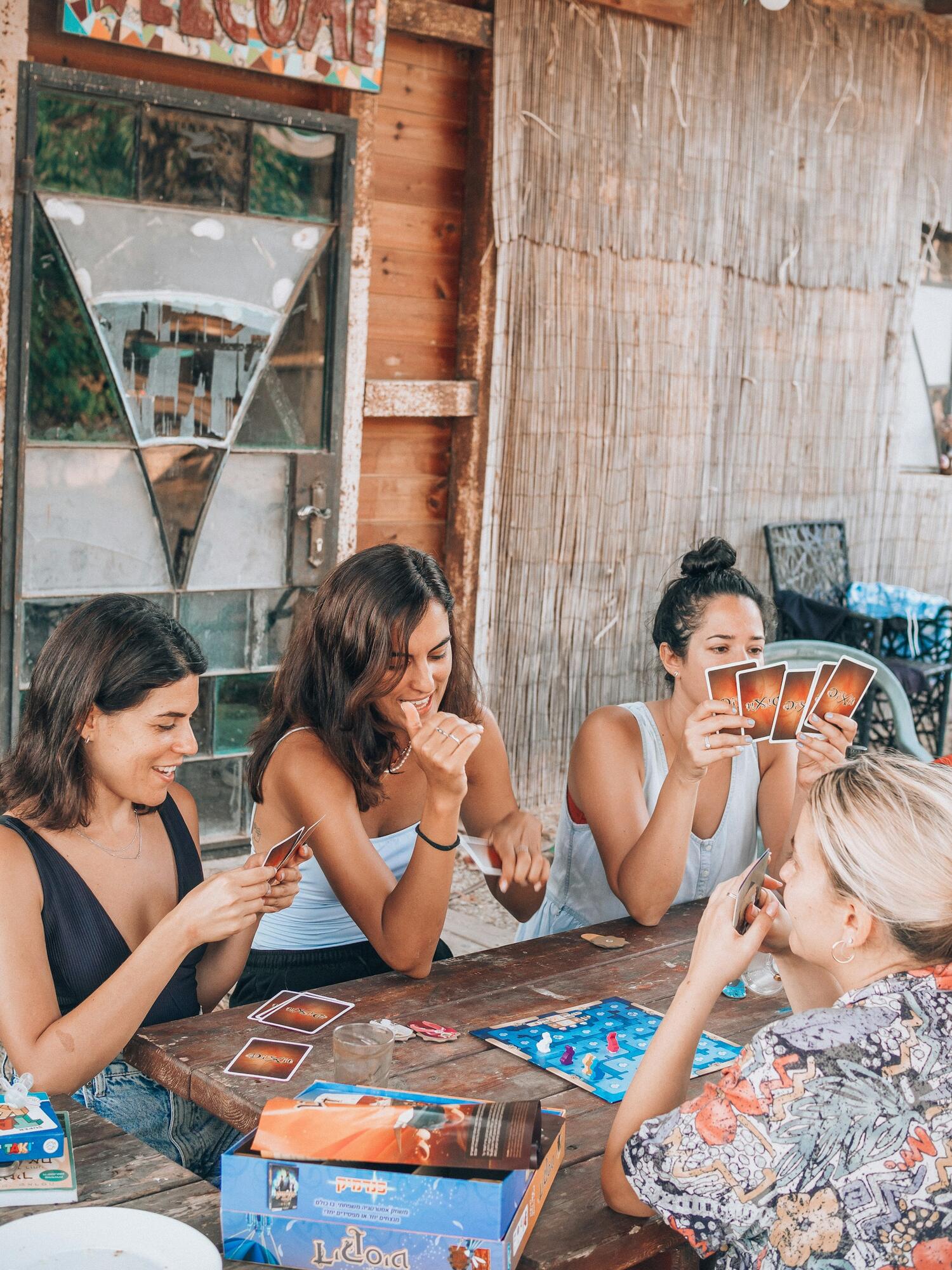 Friends laughing around a table during a game